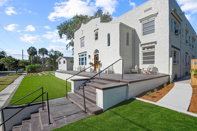 view of front of house with a patio area and a front lawn