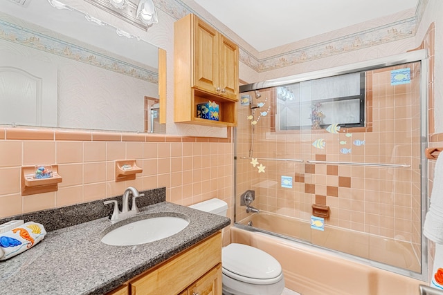 full bathroom featuring backsplash, combined bath / shower with glass door, tile walls, and toilet