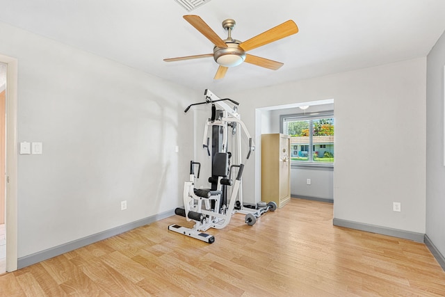 exercise area with ceiling fan and light hardwood / wood-style flooring