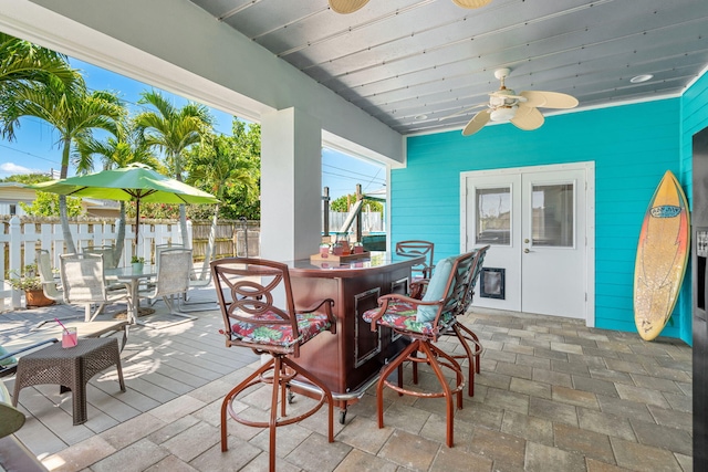 view of terrace featuring french doors and ceiling fan