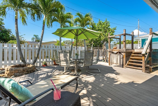 wooden deck featuring a fire pit