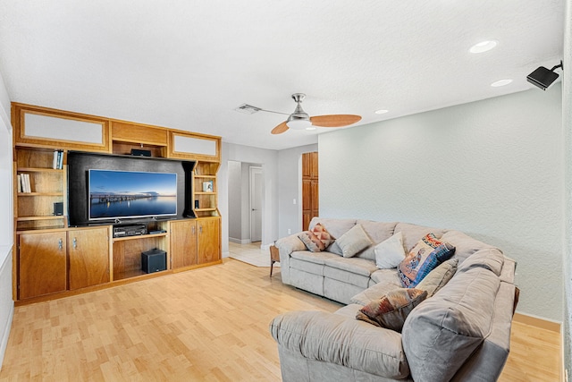 living room featuring ceiling fan and light hardwood / wood-style floors