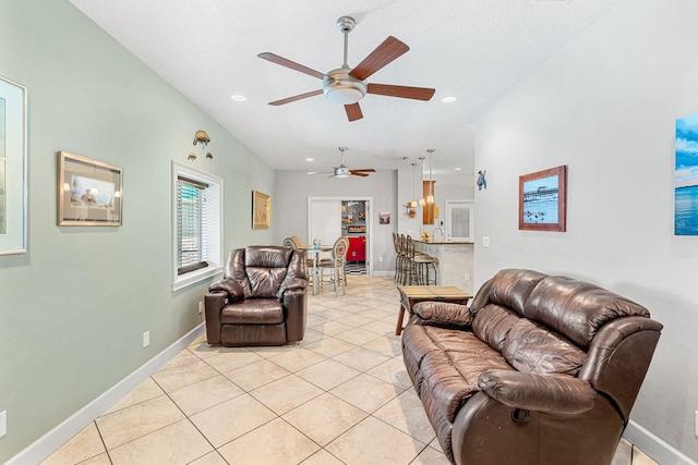 living room with ceiling fan and light tile flooring