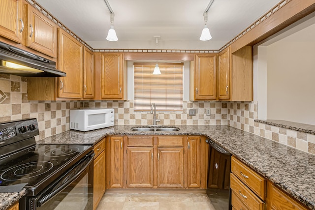 kitchen with hanging light fixtures, sink, rail lighting, and black appliances