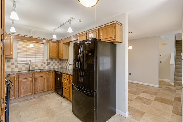 kitchen with black appliances, sink, hanging light fixtures, and tasteful backsplash