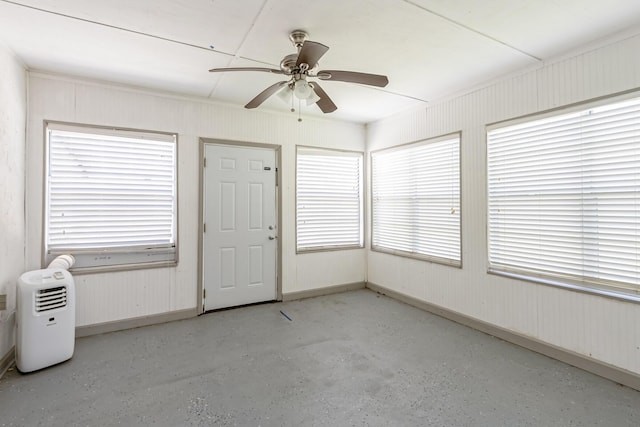 unfurnished sunroom featuring ceiling fan