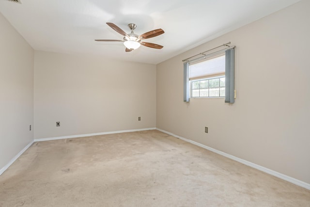 carpeted spare room featuring ceiling fan