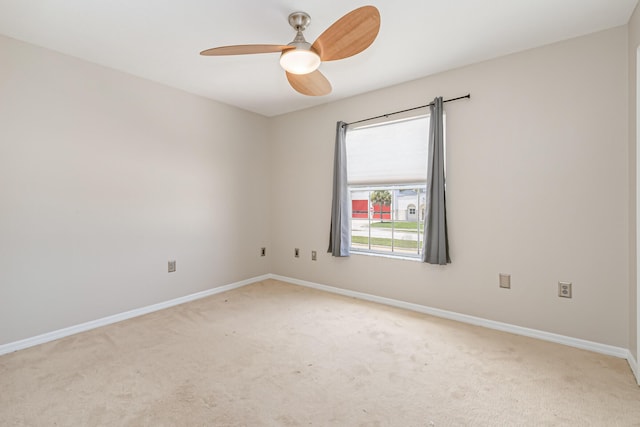 unfurnished room featuring light carpet and ceiling fan