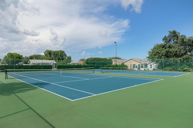 view of tennis court featuring basketball court