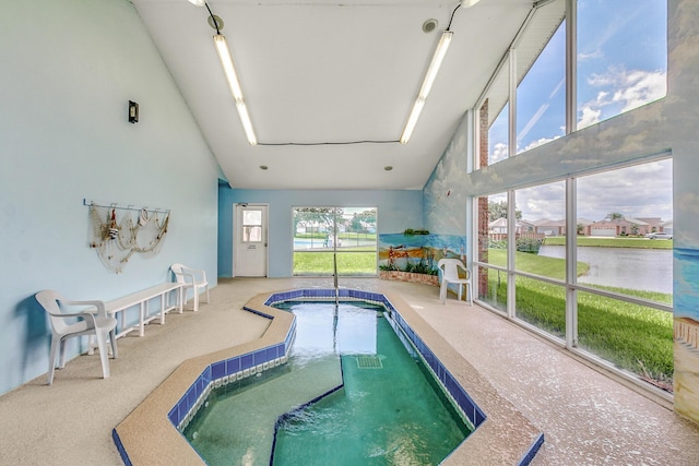 view of pool featuring a water view