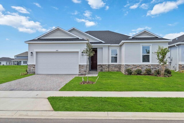 view of front of house with a front lawn and a garage