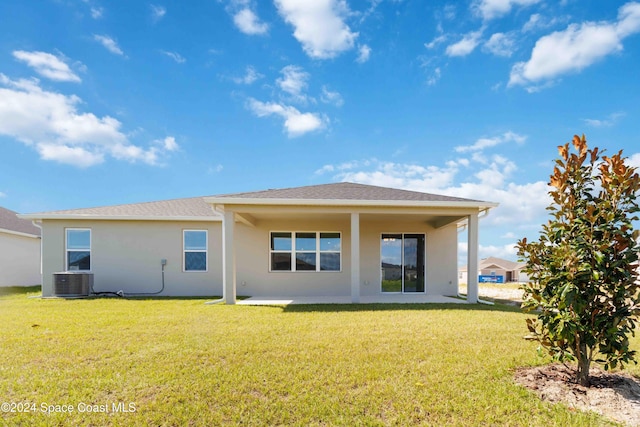 back of house with a lawn, a patio, and central AC unit