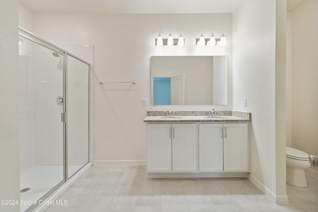 bathroom with tile patterned flooring, toilet, vanity, and walk in shower