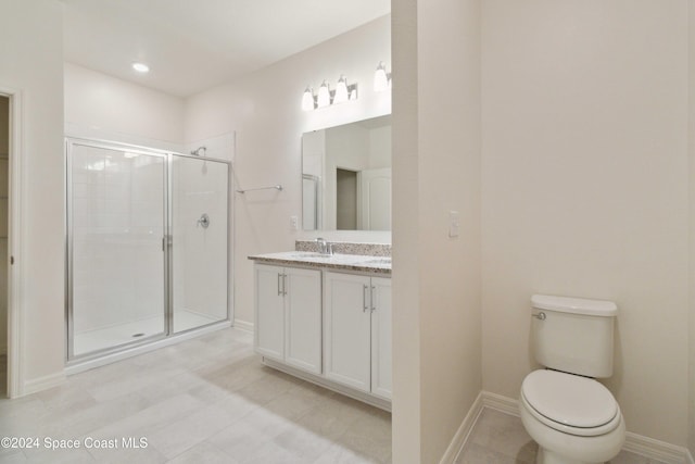 bathroom featuring a shower with door, vanity, and toilet