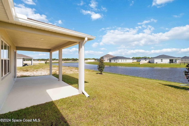 view of yard with a patio and a water view