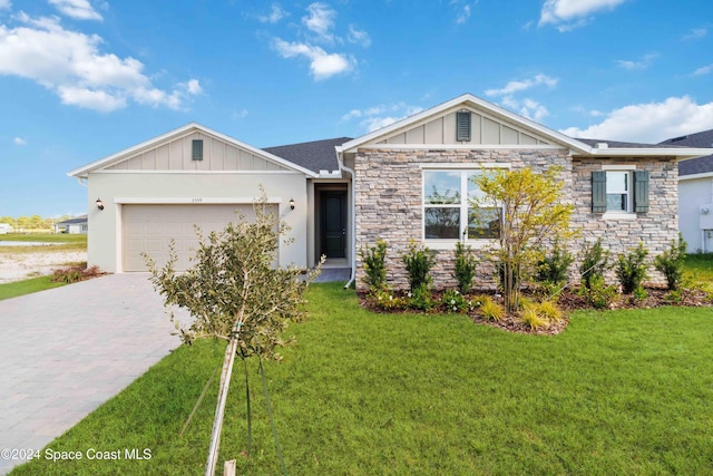 single story home featuring a front yard and a garage