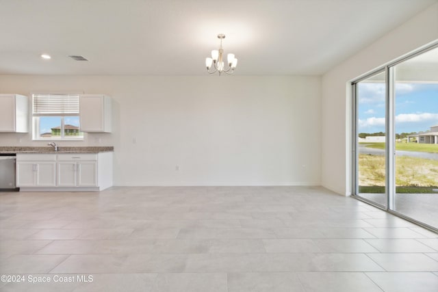 interior space featuring sink, light tile patterned floors, and a chandelier