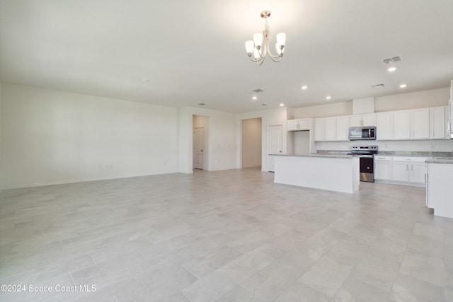 kitchen featuring white cabinets, appliances with stainless steel finishes, decorative light fixtures, a kitchen island, and a chandelier