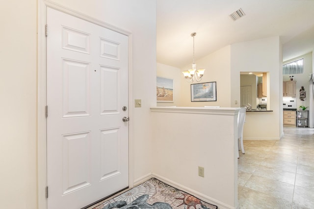 foyer featuring an inviting chandelier