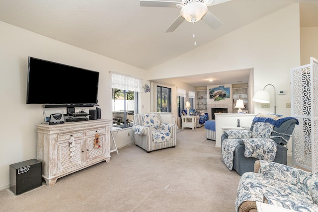 carpeted living room with ceiling fan, lofted ceiling, and a fireplace