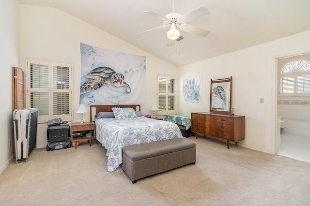 carpeted bedroom featuring vaulted ceiling, ceiling fan, and ensuite bathroom