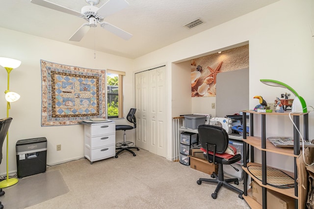 home office featuring light carpet and ceiling fan