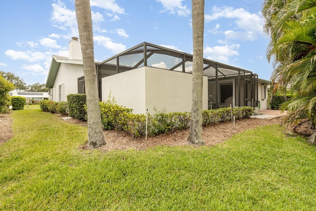 view of property exterior featuring a lanai and a lawn