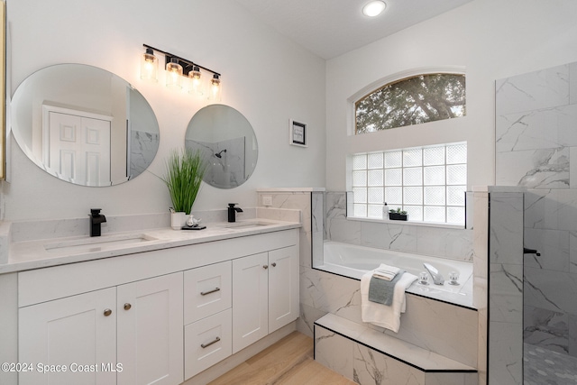 bathroom with vanity, hardwood / wood-style flooring, and independent shower and bath