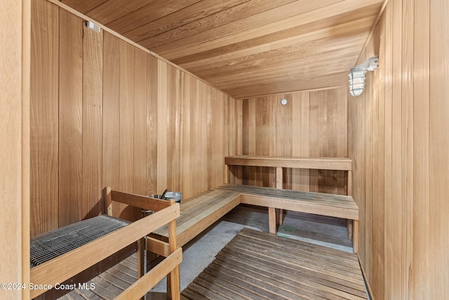 view of sauna featuring wood walls and wood ceiling