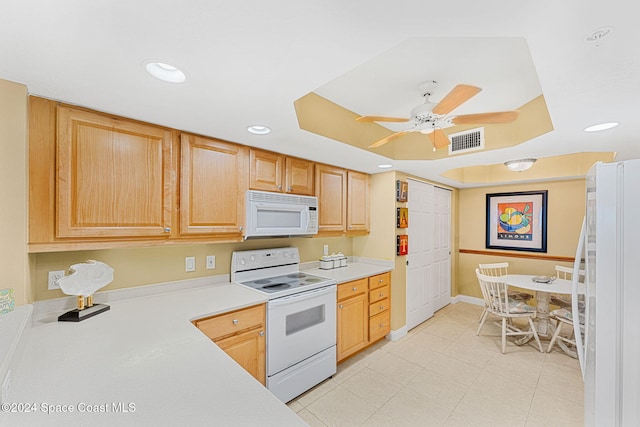 kitchen with light brown cabinetry, white appliances, and ceiling fan