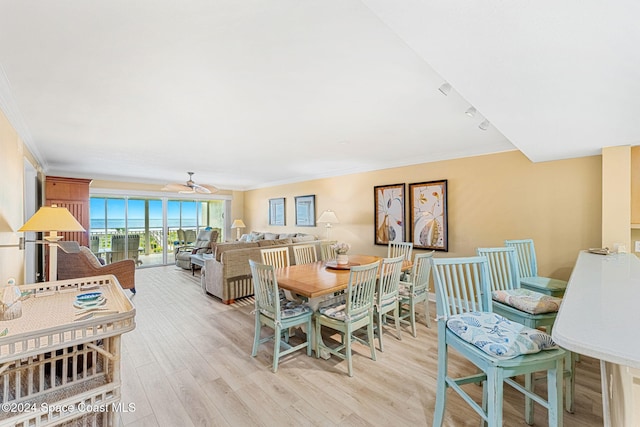 dining space with crown molding, ceiling fan, and light hardwood / wood-style floors