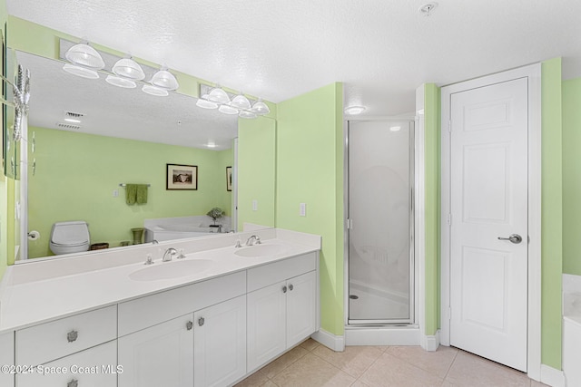 full bathroom with tile patterned floors, independent shower and bath, a textured ceiling, and toilet