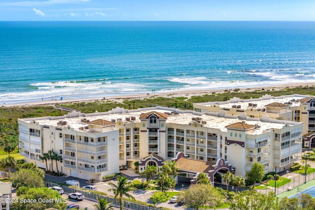 drone / aerial view featuring a water view and a view of the beach