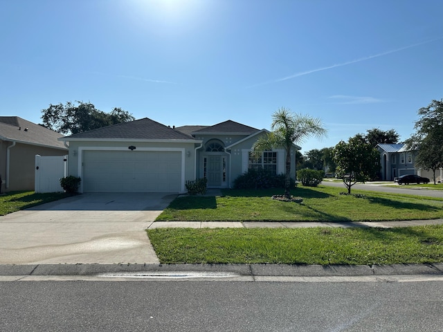 single story home with a front lawn and a garage