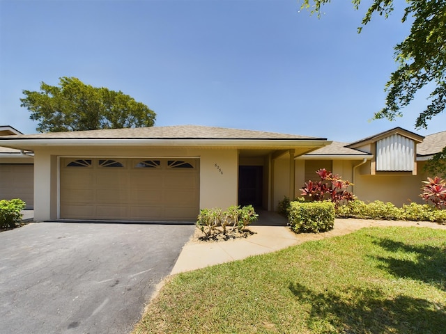 6256 Mirror Lake Ct Unit 6256, Sebastian, FL 32958 - view of front facade with a garage and a front lawn