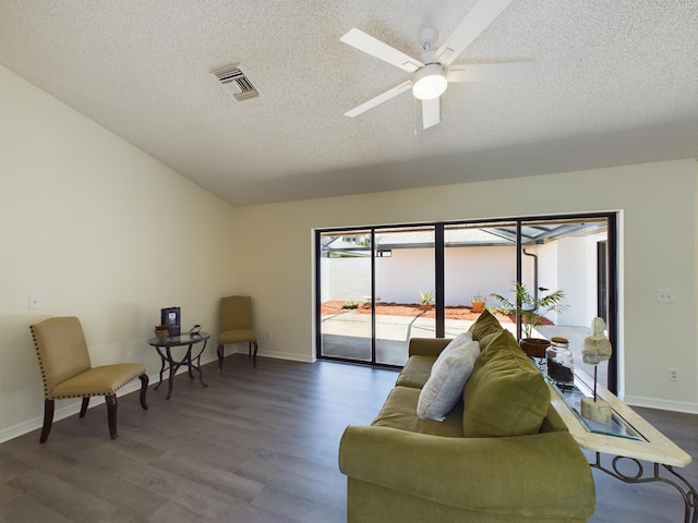 living room with ceiling fan, wood-type flooring, and a textured ceiling