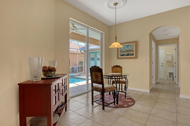 dining area featuring ceiling fan and light tile patterned floors