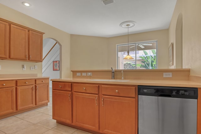 kitchen featuring ceiling fan, sink, hanging light fixtures, stainless steel dishwasher, and light tile patterned flooring