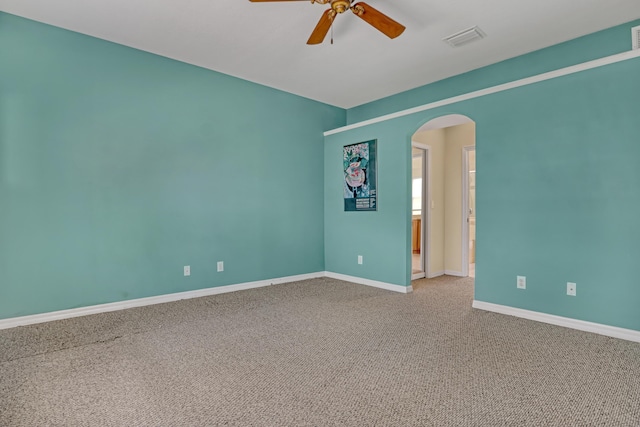 carpeted empty room featuring ceiling fan