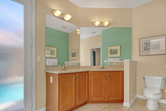 bathroom featuring tile patterned floors, vanity, and toilet