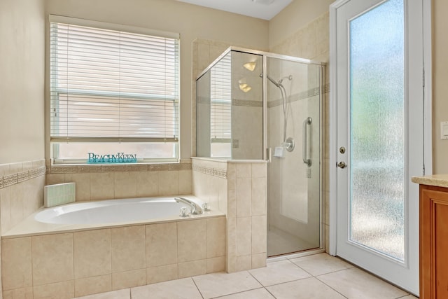 bathroom with separate shower and tub and tile patterned floors