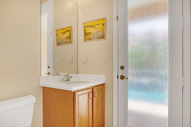 bathroom featuring vanity and toilet