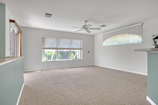 spare room with light carpet and ceiling fan