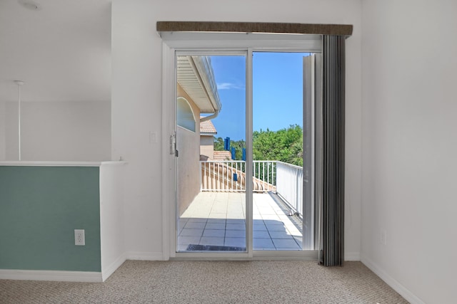 doorway with carpet floors and plenty of natural light