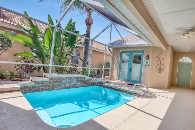 view of pool featuring ceiling fan, french doors, a lanai, a hot tub, and a patio area