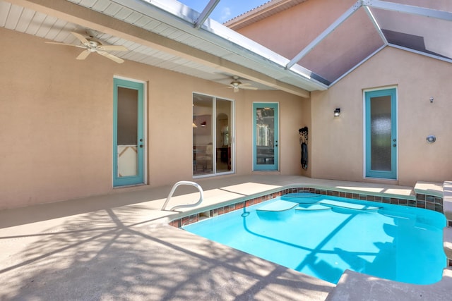 view of pool with glass enclosure, ceiling fan, and a patio