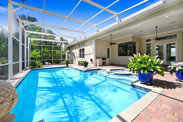 view of swimming pool with french doors, glass enclosure, an in ground hot tub, ceiling fan, and a patio