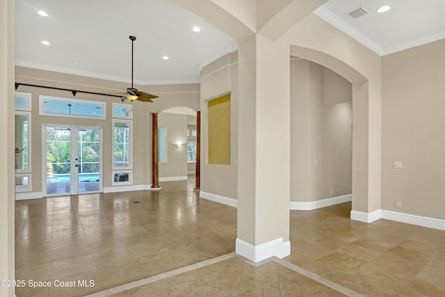 spare room featuring crown molding, ceiling fan, and french doors