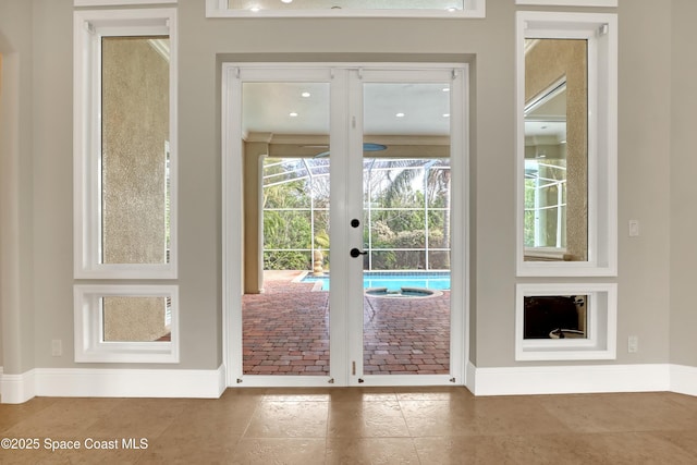 doorway with tile patterned floors and french doors