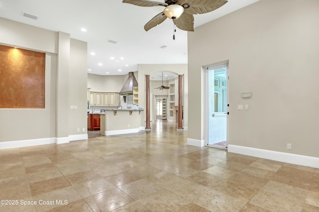 unfurnished living room with ceiling fan